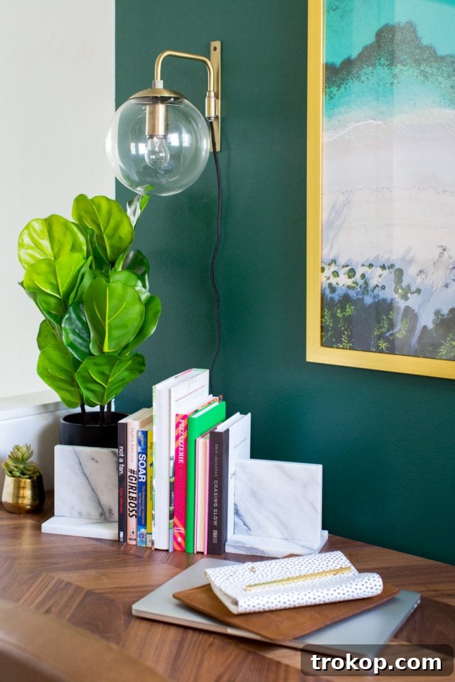 Organized desk space with a laptop, decor, and a framed photo, showcasing the herringbone desktop