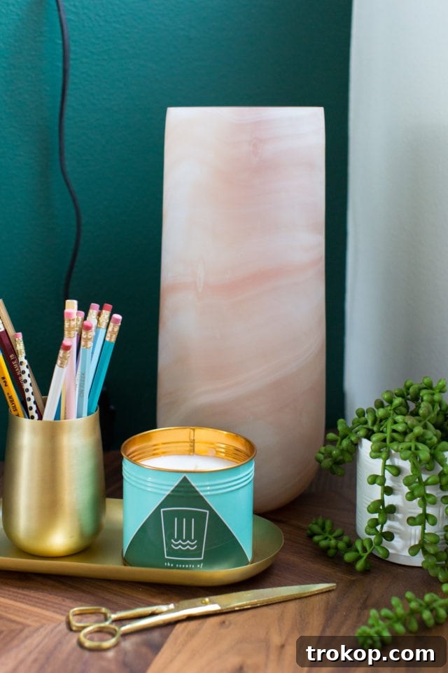 Stylish white filing cabinets with gold legs underneath the desk in the renovated home office