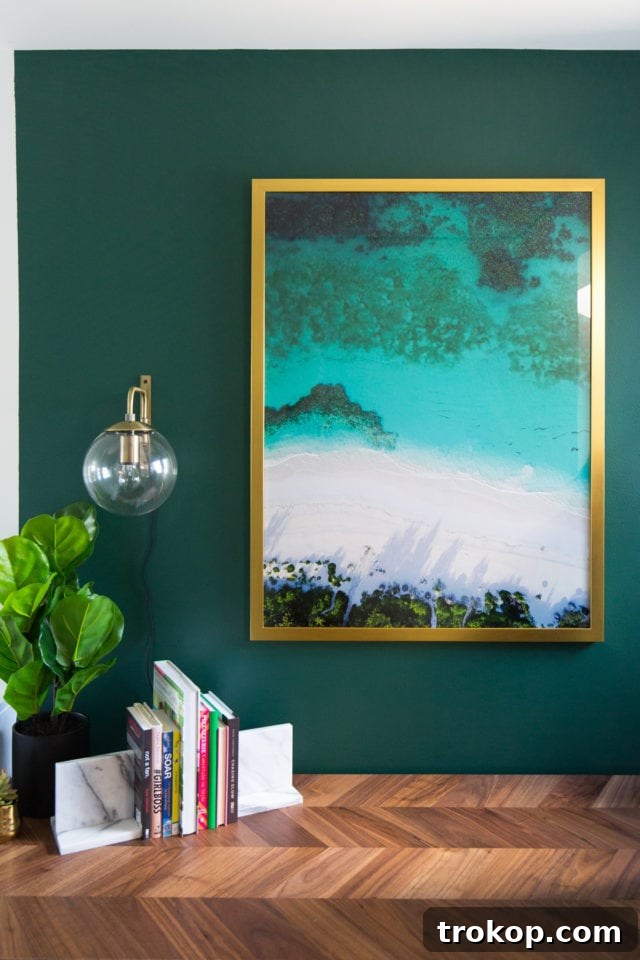 Painter carefully cutting in around the edges of the green accent wall in the study nook