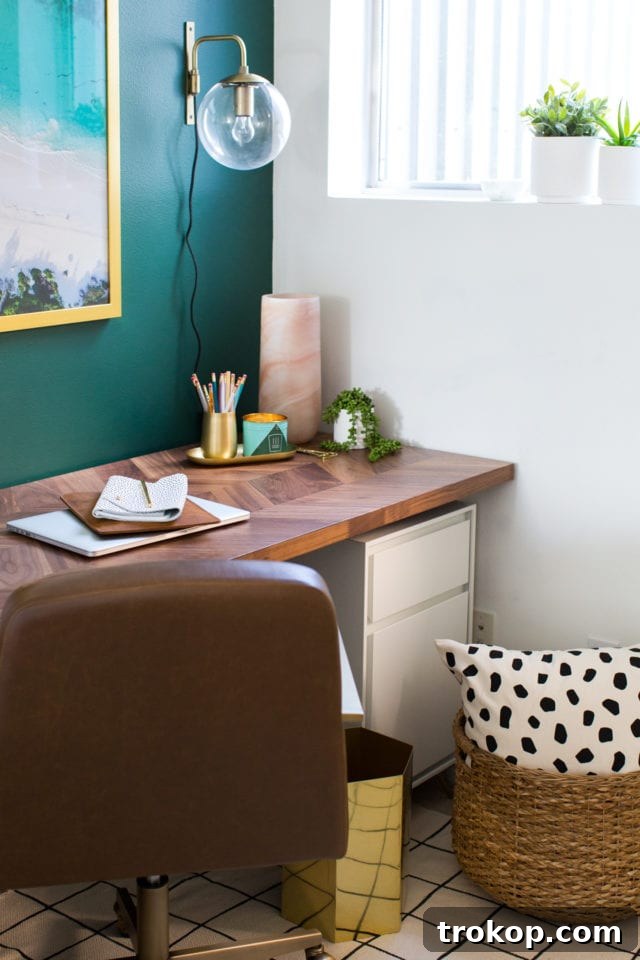 Close-up of the smooth eggshell finish of the BEHR Equilibrium green paint on the accent wall
