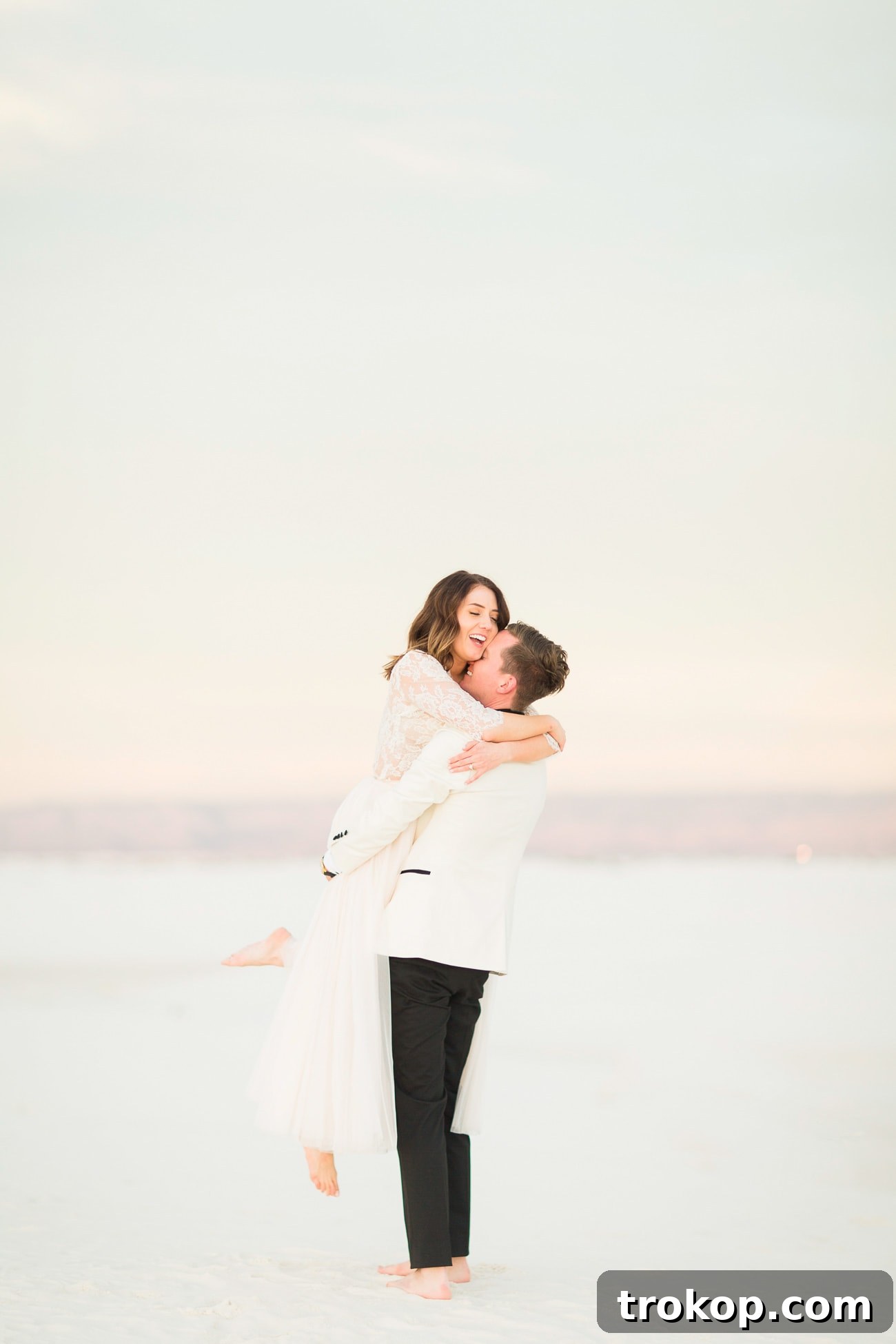 Bride and groom holding hands in the stunning White Sands National Monument