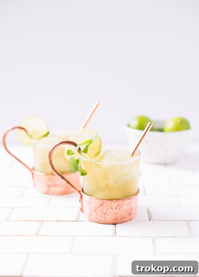 Close-up of a Moscow Mule Float in a copper mug, garnished with lime and mint