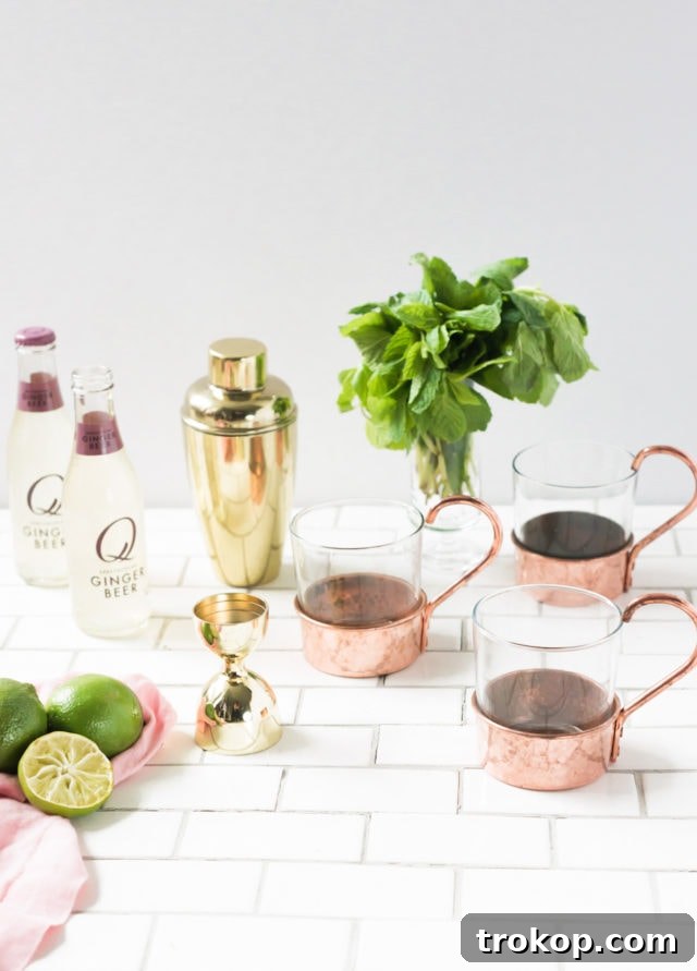 Ingredients for Moscow Mule Float, including ginger beer, vodka, and limes