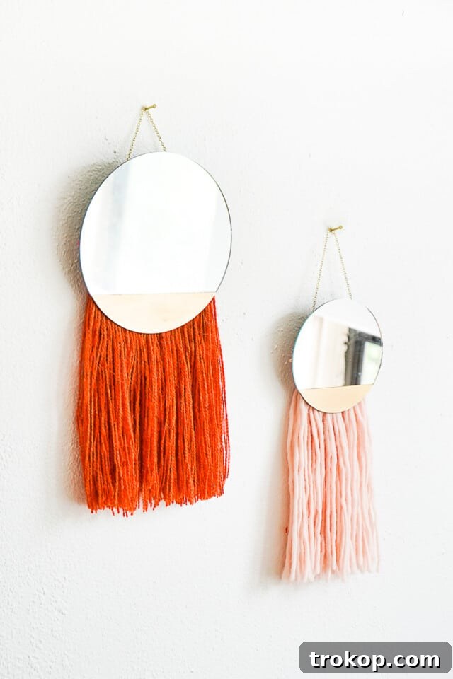 The DIY Fringe Boho Mirror hung on a wall, showcasing its completed design and aesthetic.