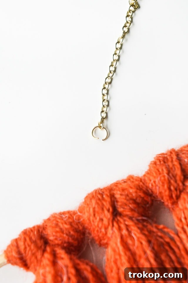 Step 5: Attaching jump rings to the ends of the gold link chain.