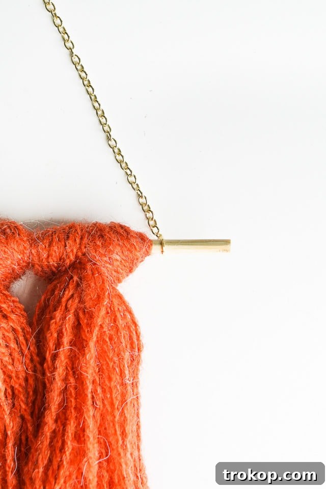 Step 6: Gold chain connected to the wooden skewer with jump rings, forming the hanger.