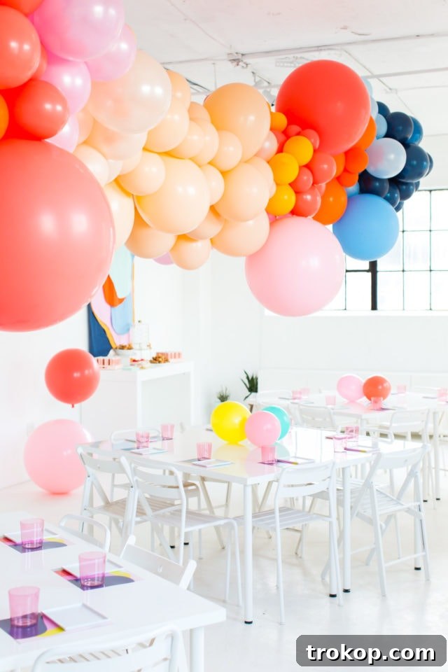 Colorful balloon garland and DIY fabric wall hanging at the charity workshop