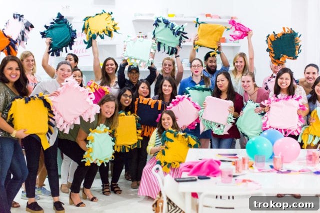 Volunteers proudly displaying completed DIY pet pillows