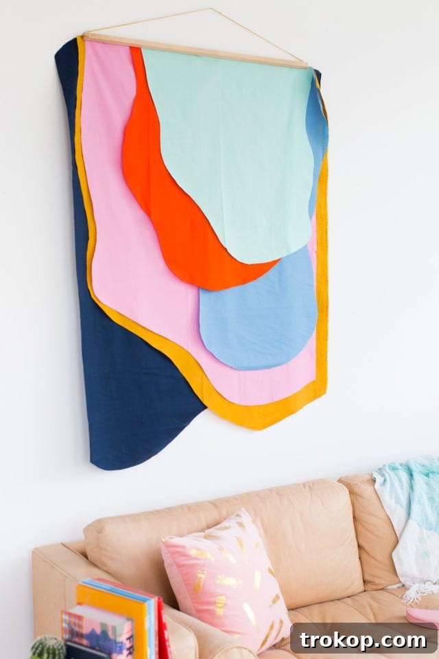 Completed colorful DIY Fabric Wall Hanging displayed in a stylish room, highlighting its vibrant impact on home decor