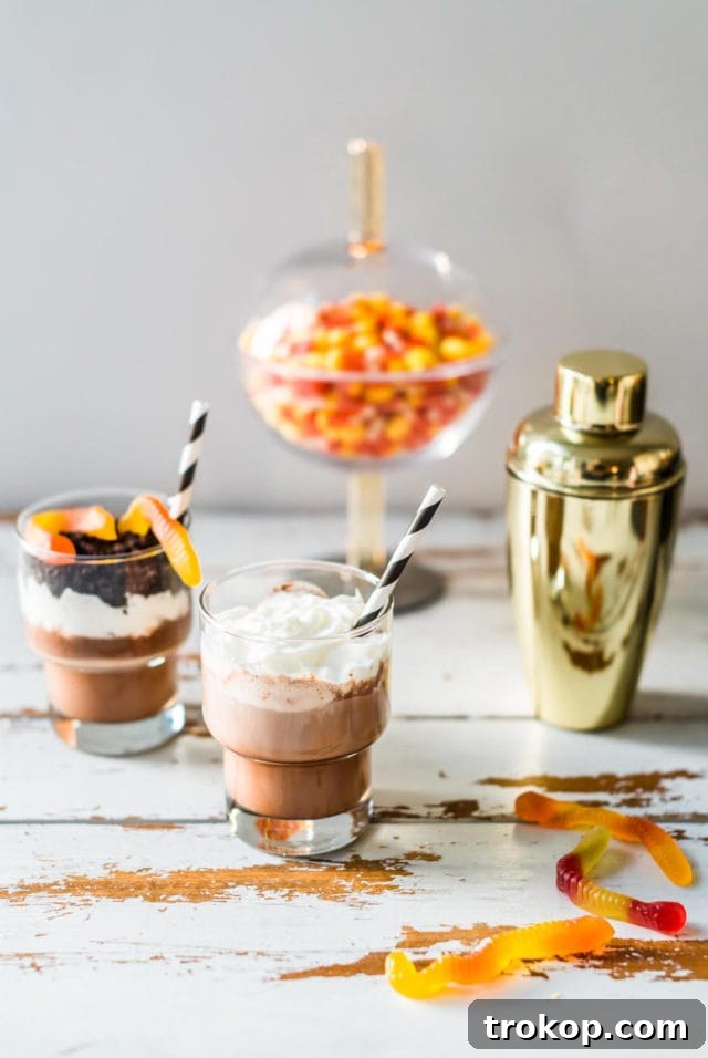 Overhead view of several Boozy Dirt Cups with vibrant garnishes