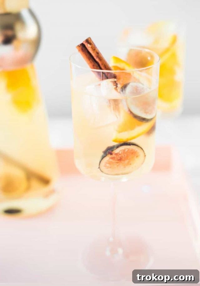 Autumn Fig Apple Cider Sangria 2 Refreshing Fig Apple Cider Sangria, a perfect autumn white wine cocktail featuring seasonal fruits like apples, oranges, pears, and figs.