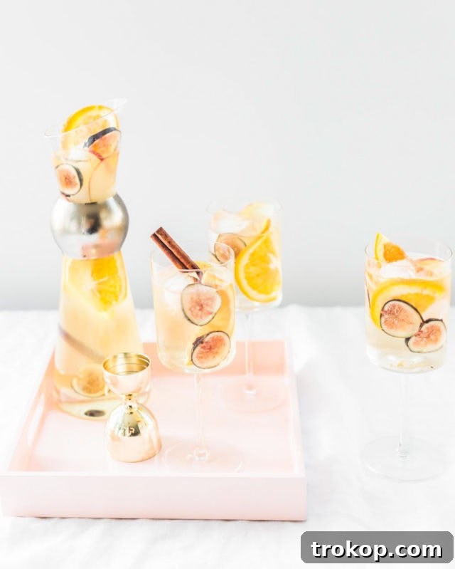 Autumn Fig Apple Cider Sangria 8 A festive spread featuring a pitcher of Fig Apple Cider Sangria, surrounded by fresh figs, apples, and autumnal decor, perfect for a fall celebration.