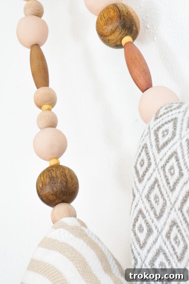 Close-up of the elegant wood and polymer clay beads used in the DIY blanket holder project.