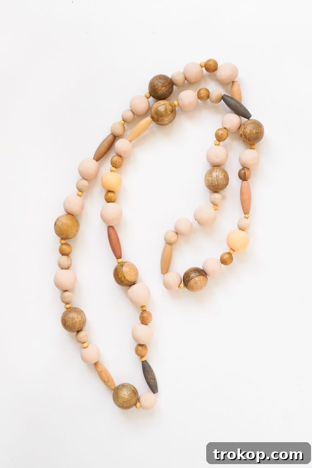 The two ends of the beaded string tied together with a secure knot, forming a loop.