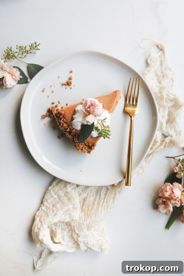 Gingersnap Pumpkin Pie Recipe Garnished with Cinnamon Sticks
