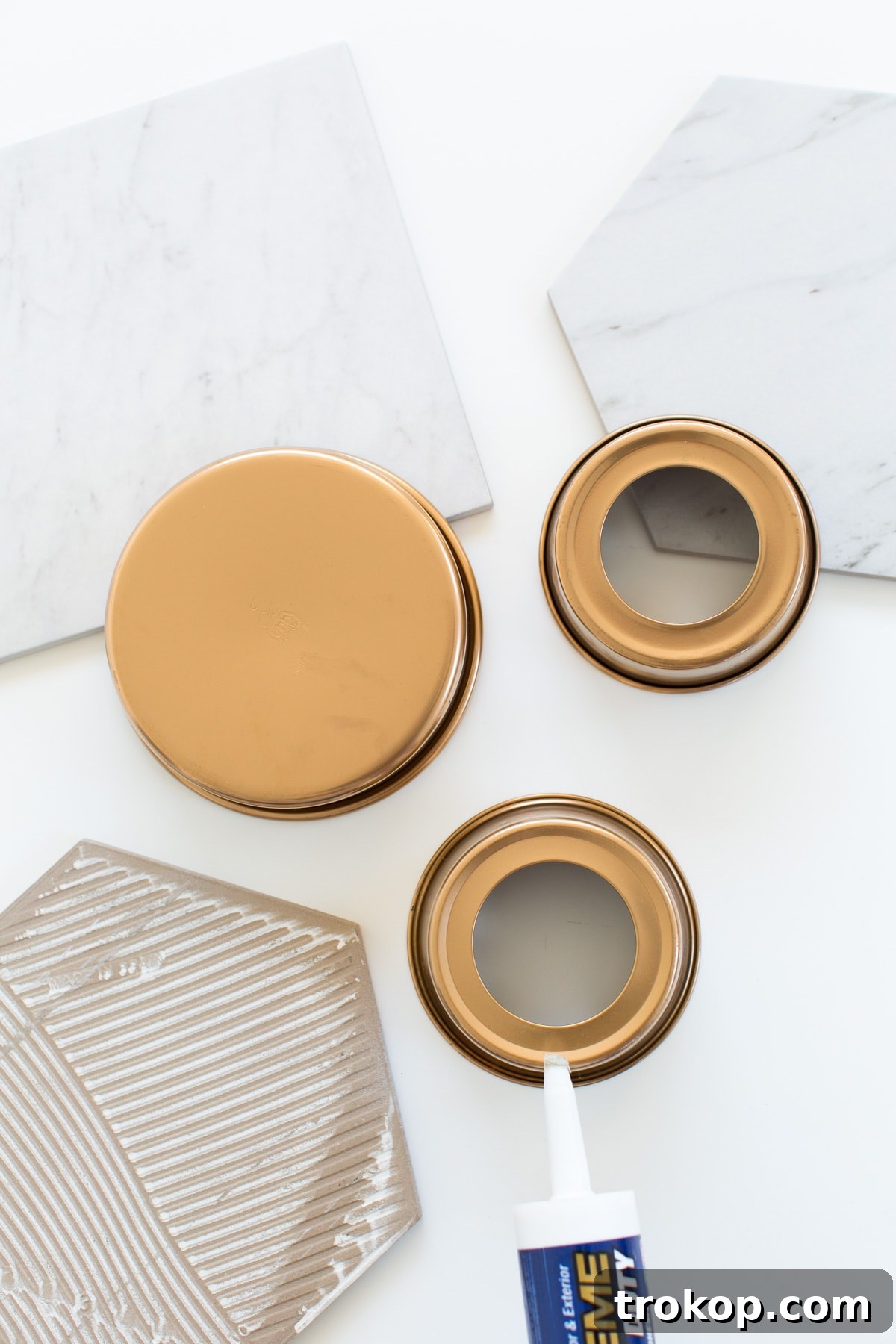 DIY Marble & Gold Serveware showing a cake pan being spray painted gold