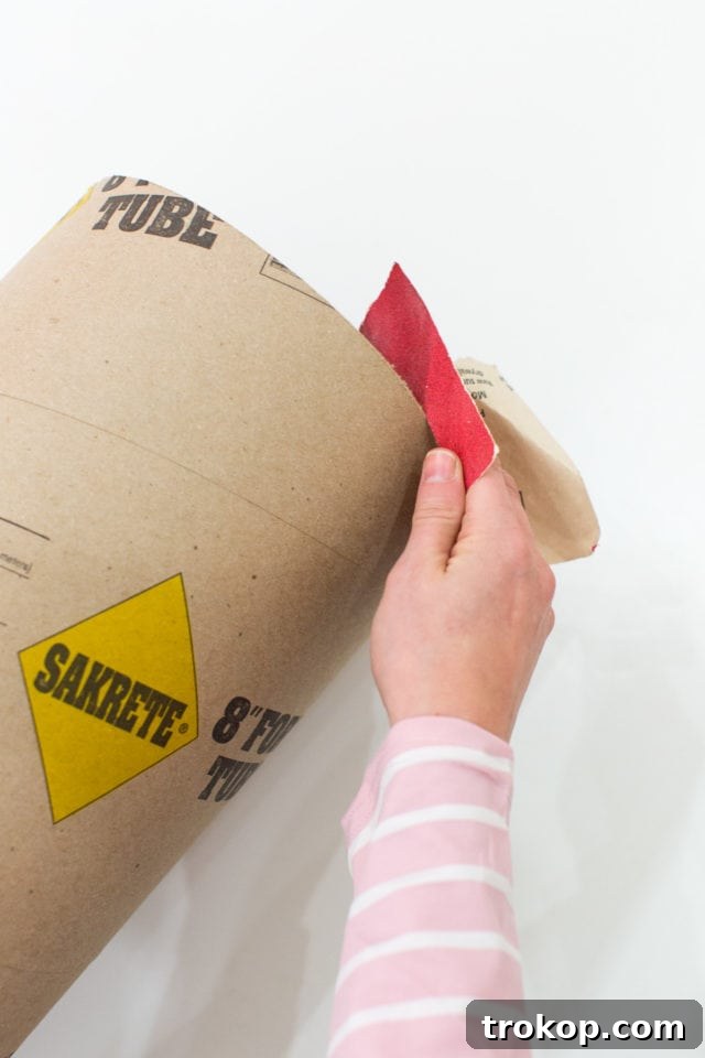 Epic DIY Confetti Blasts 6 Sanding the cut edges of the cardboard tube for a smooth finish