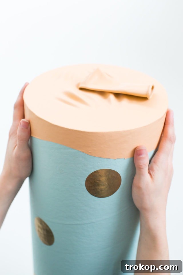 Epic DIY Confetti Blasts 9 Stretching the cut balloon tightly over the end of the cardboard tube