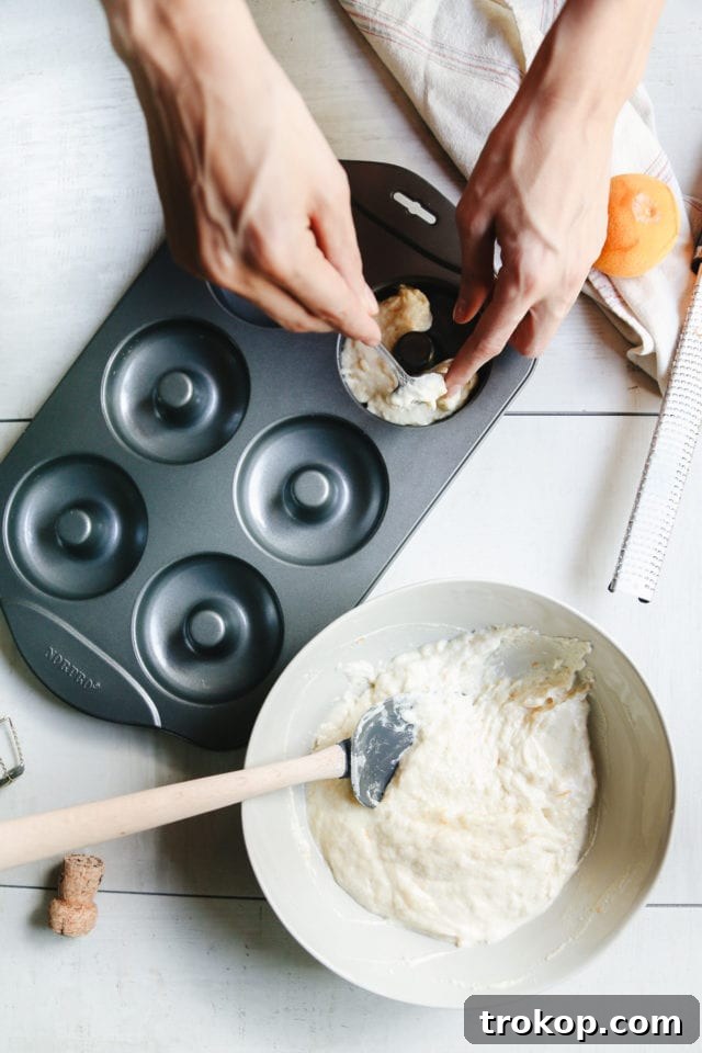 Champagne Infused Doughnuts with Velvety White Chocolate Glaze 6 Champagne Donut batter in a donut pan ready for baking by Ashley Rose of Sugar and Cloth