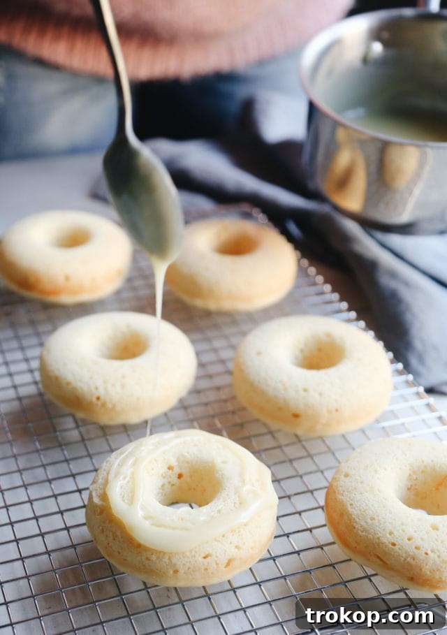 Champagne Infused Doughnuts with Velvety White Chocolate Glaze 8 Smooth white chocolate glaze with a hint of champagne for donuts by Ashley Rose of Sugar and Cloth