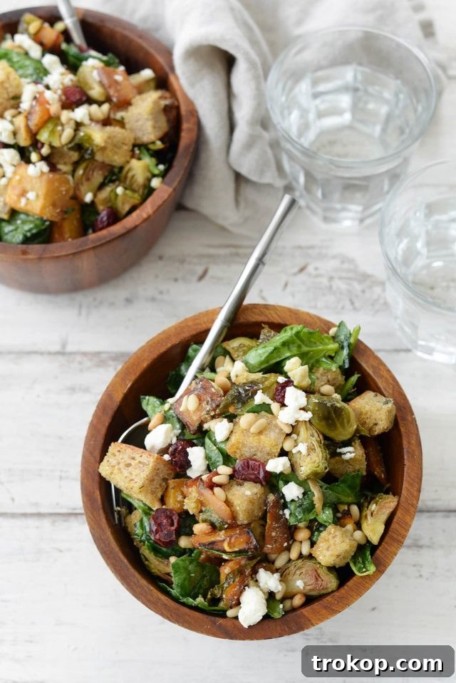 A beautifully plated Winter Panzanella Salad with roasted vegetables, cranberries, and feta.