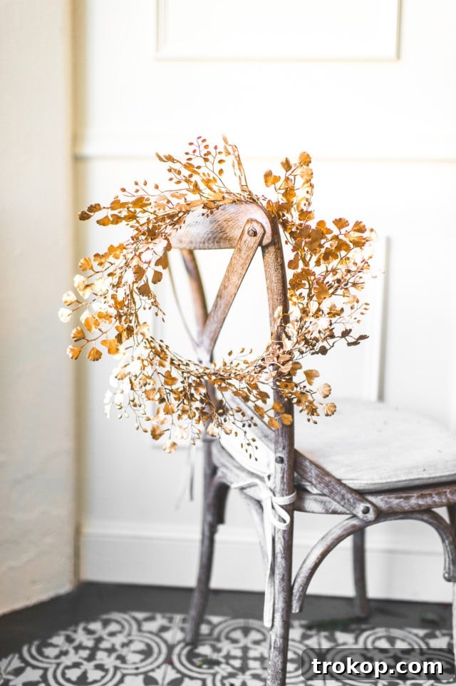 Shimmering Gold DIY: Wreaths & Garlands 2 DIY Golden Wreath hanging on a white wall, offering year-round sparkle and home elegance.