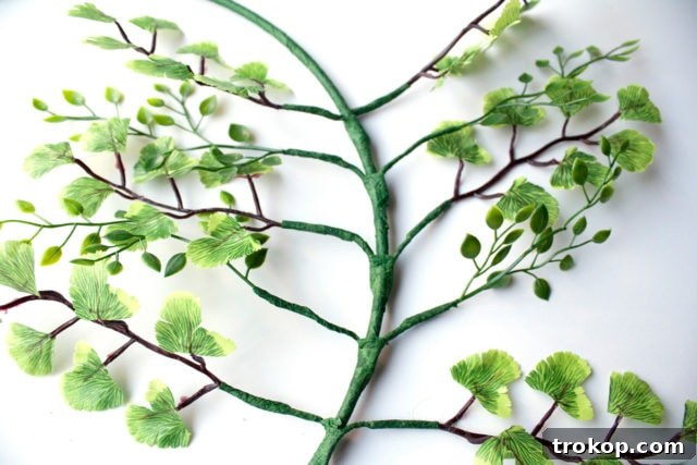 Shimmering Gold DIY: Wreaths & Garlands 11 Step 6: Continuing to attach various leaf types around the wreath ring with floral tape, alternating for a full look.