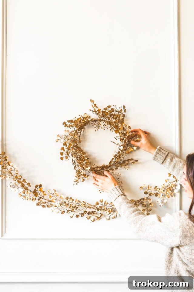 Shimmering Gold DIY: Wreaths & Garlands 4 Finished DIY Gold Wreath and Garland elegantly draped on a light-colored wall, adding a radiant touch to the room.