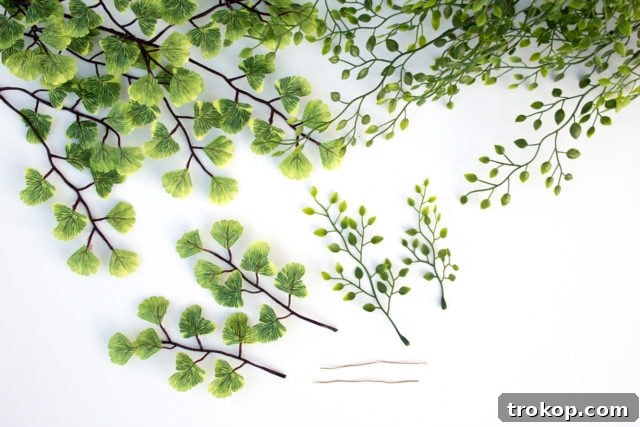 Shimmering Gold DIY: Wreaths & Garlands 5 Array of materials and tools needed for the DIY Golden Wreath and Garland project, including leaves, wire, tape, and spray paint.