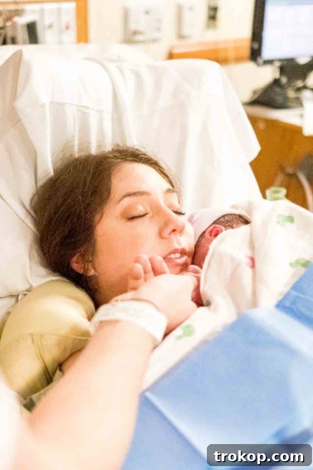 Little Sugar and Cloth Gwen's Birth Journey 4 Pregnant woman in hospital gown with partner and doula, looking calm and prepared.