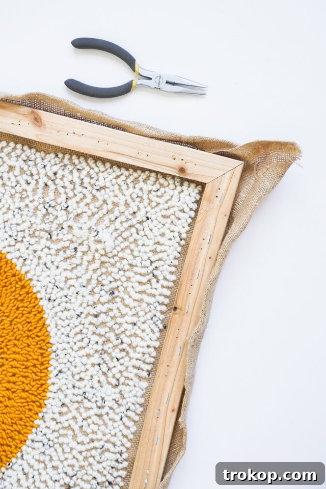 How to Make a Rug Hooked Pillow 16 Step 10: Removing the completed rug hooked burlap panel from the wooden stretcher frame.