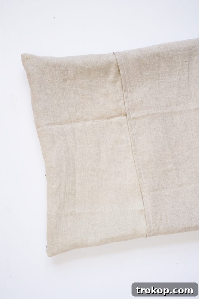 How to Make a Rug Hooked Pillow 20 Step 14: Turning the finished pillow cover right side out, showcasing the handmade rug hooked design.