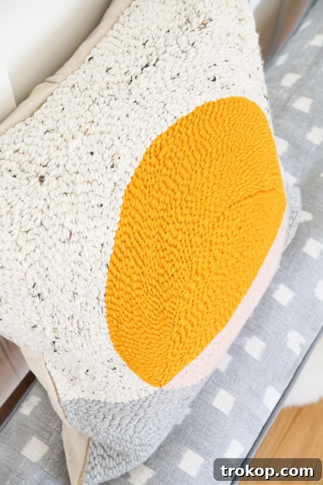 How to Make a Rug Hooked Pillow 4 Assortment of rug hooking supplies including yarn, punch needle, and burlap, set up for a DIY project.