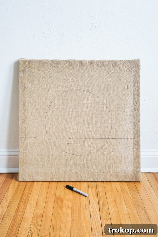 How to Make a Rug Hooked Pillow 7 Step 1: Securing burlap to a wood frame with a staple gun, stretching it taut for rug hooking.