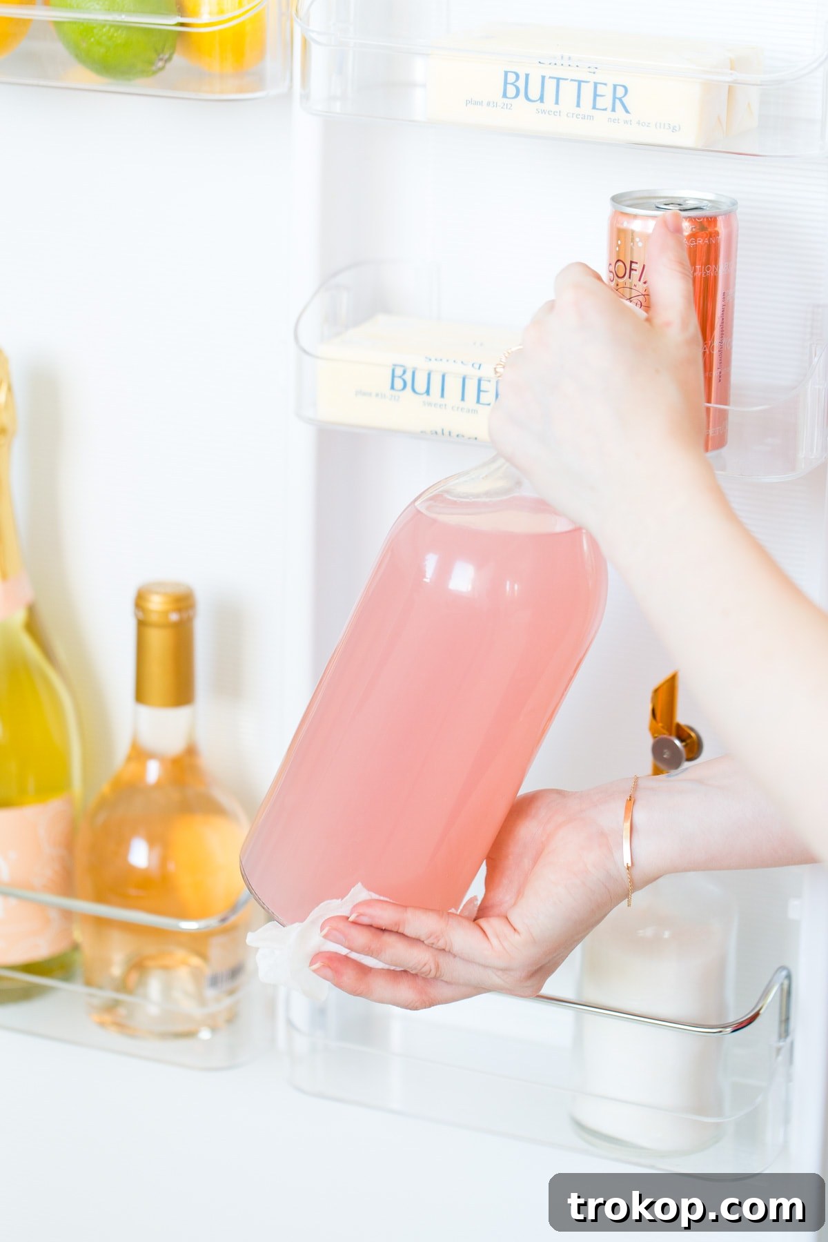 6 Unexpectedly Delightful Hacks for a Sparkling Spring Fridge 5 Refrigerator with a lazy susan organizing condiments and jars