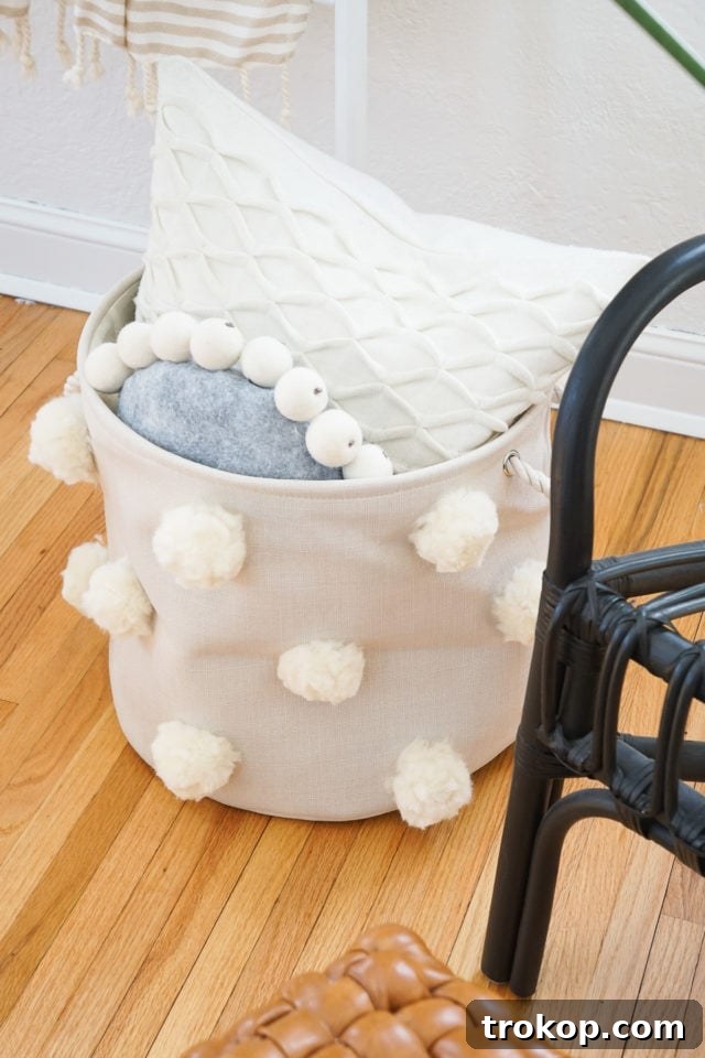 Beautiful Fluffy DIY Pom Pom Bin with soft, neutral tones.