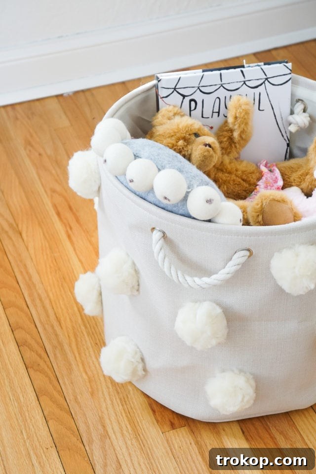 Craft Your Own Fluffy Pom Pom Storage Basket 12 Detail shot of the fluffy pom poms on the storage bin.