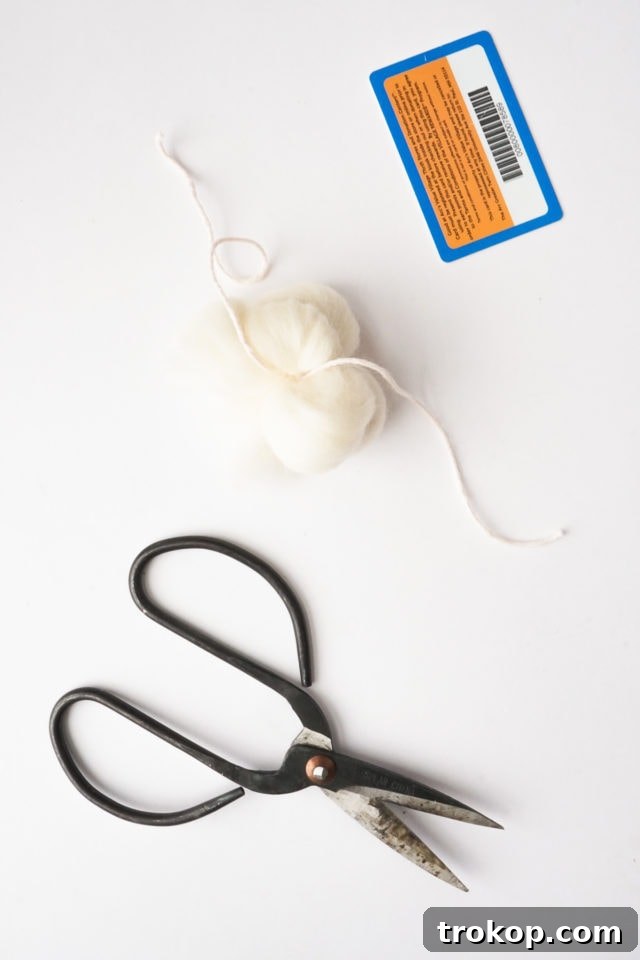 Sliding wool roving off the card and tying it in the middle.