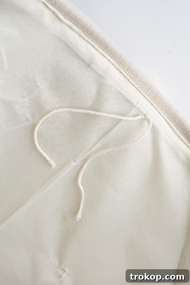 Close-up of a pom-pom securely attached to the fabric bin.
