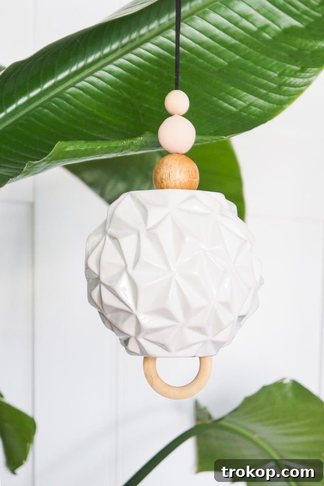 Collection of materials for a DIY wind chime: vase, cording, beads, and a wooden ring