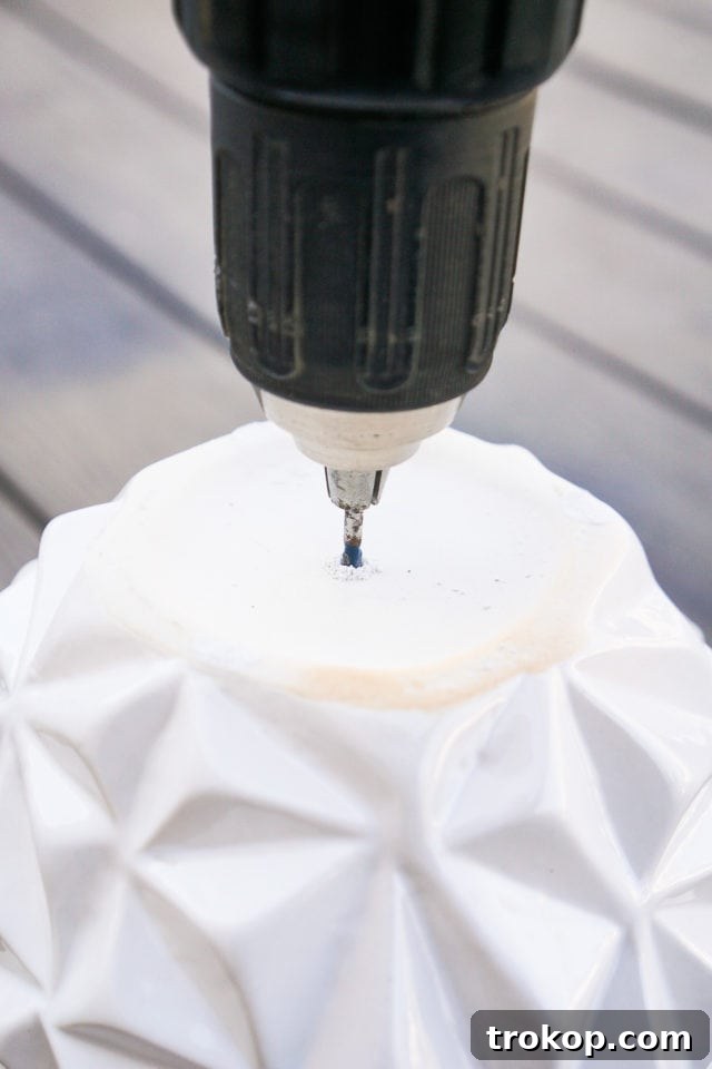Instructions for drilling a hole in the bottom of a vase for a DIY wind chime project