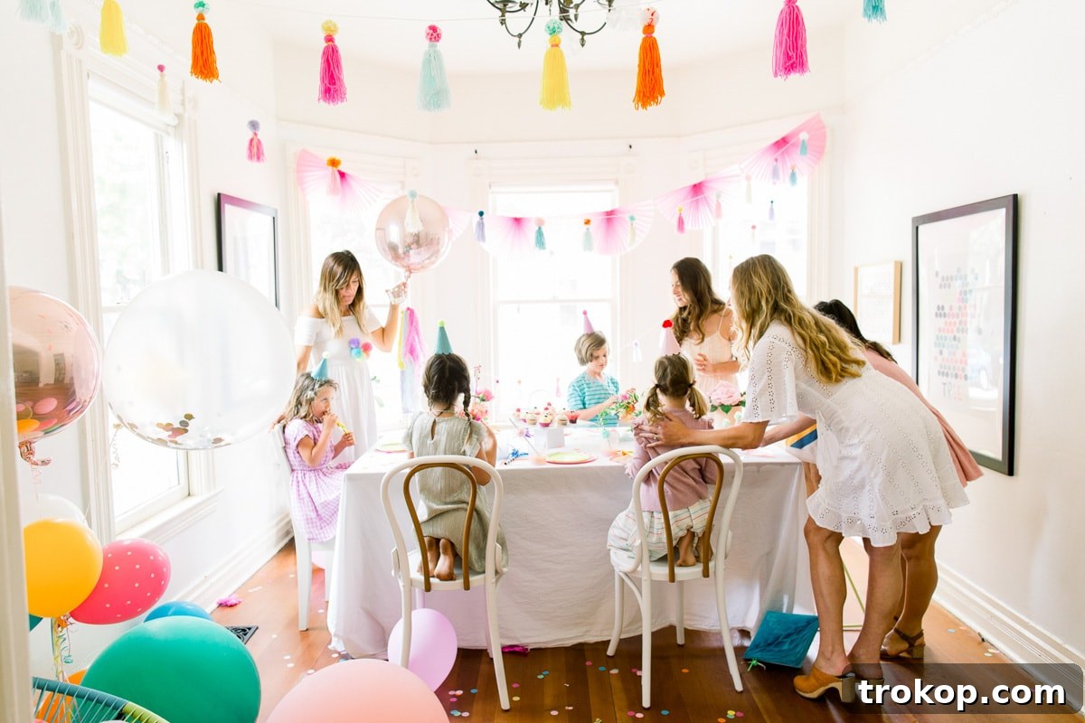 A charming close-up of colorful pom pom decorations and party supplies from Sugar & Cloth, highlighting the intricate details of the birthday party theme.