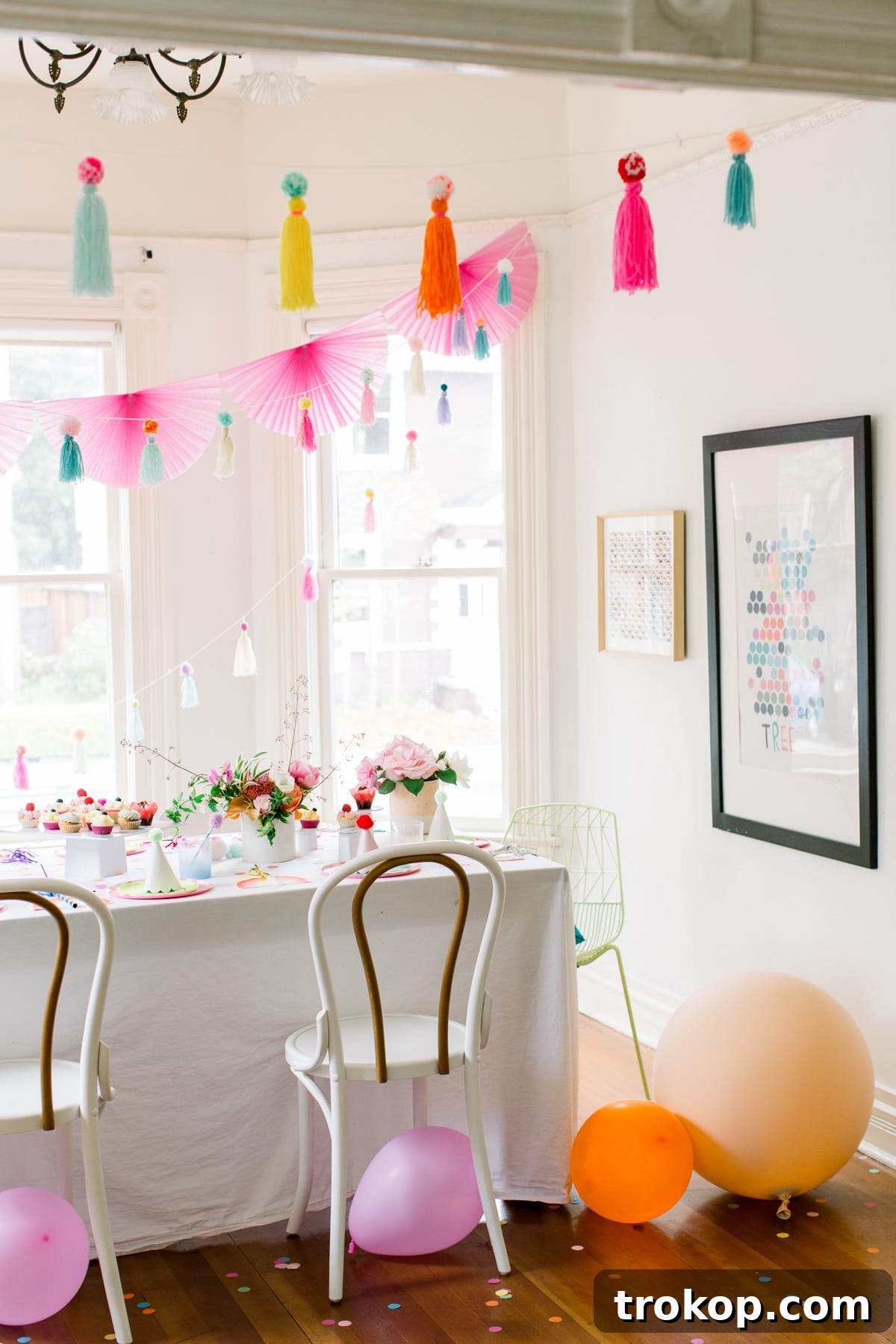 Detail of a festive drink station at the pom pom party, featuring ombre pitchers, cups, and striped straws from Sugar & Cloth.