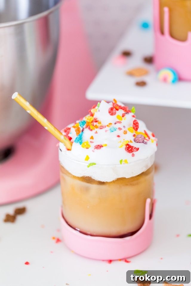 The Ultimate Cereal Milk Cold Brew 3 Close-up of cereal milk cold brew with ice, showing the creamy texture and cereal bits, by top Houston lifestyle blogger Ashley Rose of Sugar and Cloth