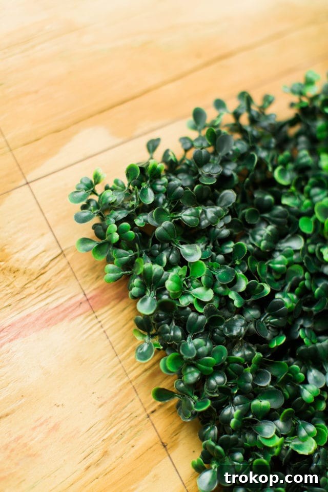 Lush Greenery Meets Neon Radiance 16 Measuring and marking boxwood panel placement