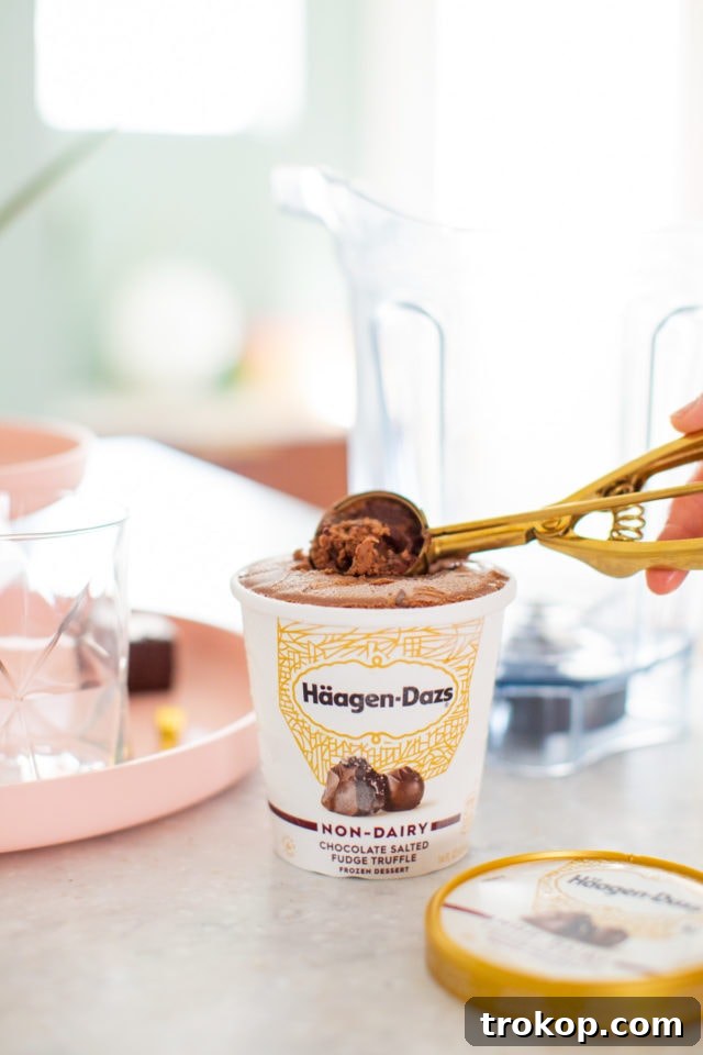 Enjoying a delicious, creamy Chocolate Salted Fudge Truffle Dairy-Free Milkshake topped with coconut whipped cream