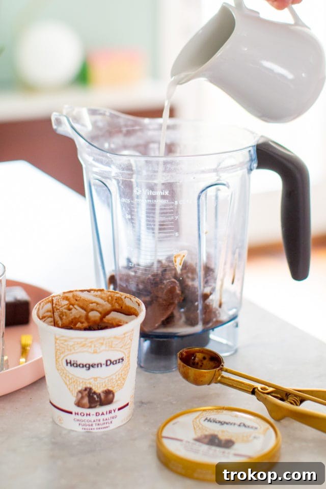 Closeup of creamy Chocolate Salted Fudge Truffle Dairy-Free Milkshake, ready to be enjoyed