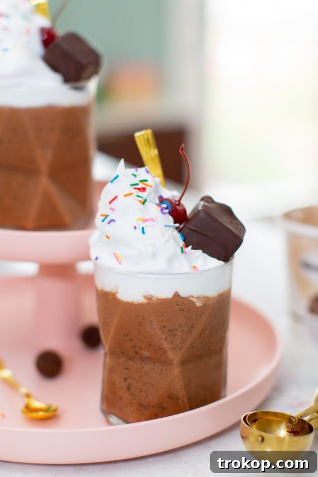 Three individual servings of Chocolate Salted Fudge Truffle Dairy-Free Milkshakes with toppings