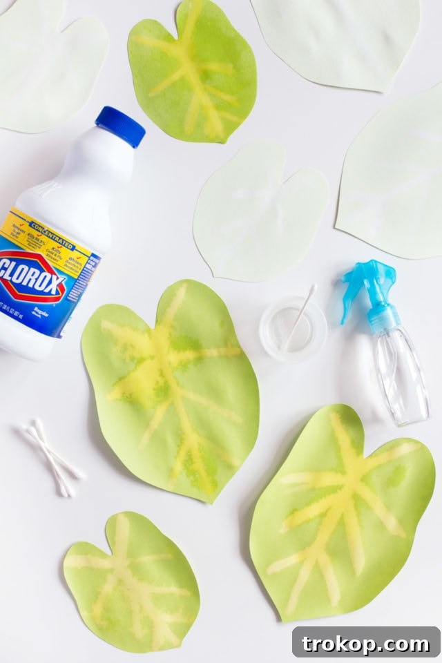 Step 2: Applying bleach to paper leaves to create natural vein patterns