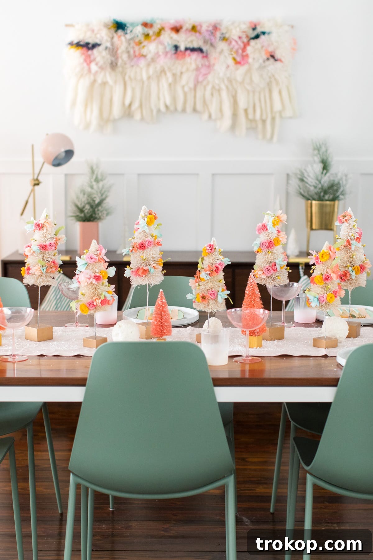 Charming DIY Floral Bottle Brush Christmas Table Decor 3 A unique Christmas table runner featuring colorful faux flower bottle brush trees amidst elegant holiday decor.